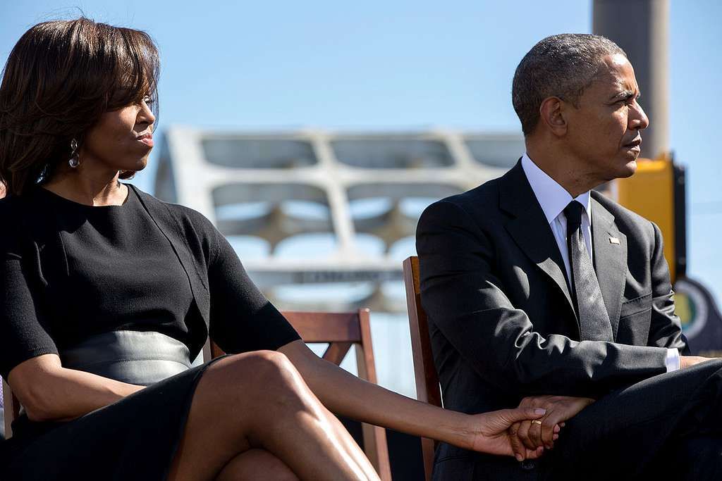 president barack obama and first lady michelle obama hold hands as they listen 753815 10246514874422891223653