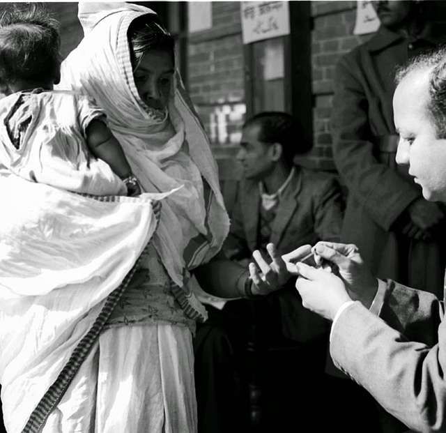 a polling officer affixes indelible ink mark on the fore finger of a voter 1bced3 6406906503537591526257