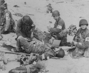 photograph-of-american-medics-rendering-first-aid-to-troops-in-the-initial-98fb47-1024950627507033148153